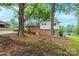 View of the home's exterior, showcasing a brick facade, siding, and backyard framed by mature trees at 1521 19Th Sw St, Hickory, NC 28602