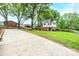 Exterior view of the home with a paved driveway, mature trees, and a well-maintained backyard at 1521 19Th Sw St, Hickory, NC 28602