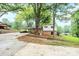 Backyard showing the home's exterior, carport, and a spacious yard surrounded by mature trees at 1521 19Th Sw St, Hickory, NC 28602