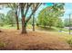 Expansive front yard with mature trees, visible from the covered porch, offering serene views at 1521 19Th Sw St, Hickory, NC 28602