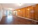 Bright living room with wood-paneled walls, large window and laminate flooring at 1521 19Th Sw St, Hickory, NC 28602