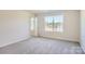 Bright bedroom with carpet, neutral walls and a large window with a view of the neighborhood at 1703 Wooten Way, Bessemer City, NC 28016