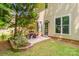 Outdoor patio with seating surrounded by landscaped greenery and flowers at 17219 Grand Central Way, Cornelius, NC 28031