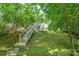 Exterior view of stairs leading to home; nestled in the trees at 17219 Grand Central Way, Cornelius, NC 28031