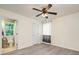This bedroom features gray wood flooring, a lighted ceiling fan and a view of a bright bathroom with a toilet at 17219 Grand Central Way, Cornelius, NC 28031