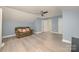 Bonus room with hardwood floors, a ceiling fan, and a large couch with pillows at 17219 Grand Central Way, Cornelius, NC 28031