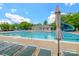Resort-style community pool with lounge chairs, umbrella, and splash pad at 17219 Grand Central Way, Cornelius, NC 28031