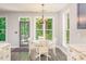 Bright dining area features a white table and chairs near kitchen area at 17219 Grand Central Way, Cornelius, NC 28031