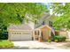 Charming two-story home featuring a welcoming front porch and attached two-car garage at 17219 Grand Central Way, Cornelius, NC 28031