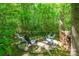 Secluded backyard fire pit area with stone pathway and plenty of seating at 17219 Grand Central Way, Cornelius, NC 28031