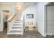 Elegant foyer featuring hardwood floors, stairs, and a charming bench area at 17219 Grand Central Way, Cornelius, NC 28031
