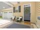 Cozy front porch with seating, decor, and a view of the garage at 17219 Grand Central Way, Cornelius, NC 28031