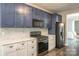 The updated kitchen offers stainless steel appliances, herringbone backsplash, and modern finishes at 17219 Grand Central Way, Cornelius, NC 28031