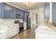 Modern kitchen features a herringbone backsplash, white countertops, and stainless steel appliances at 17219 Grand Central Way, Cornelius, NC 28031