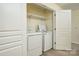 Convenient laundry room with a washer, dryer, and shelving at 17219 Grand Central Way, Cornelius, NC 28031