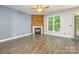 Inviting living room with a rustic fireplace, wood accent wall, and natural light at 17219 Grand Central Way, Cornelius, NC 28031