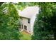 Rear exterior of home with spacious backyard, framed by mature trees at 17219 Grand Central Way, Cornelius, NC 28031