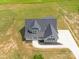 Aerial view of a gray home showing the roof, front porch, driveway, and landscaped yard at 175 Lone Pine Rd, Statesville, NC 28625