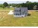 Aerial view of gray home with a spacious backyard and inviting deck at 175 Lone Pine Rd, Statesville, NC 28625