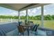 Inviting covered back porch featuring outdoor seating and serene views of the lush surrounding landscape at 175 Lone Pine Rd, Statesville, NC 28625