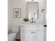 Stylish half-bath with white vanity, black fixtures, and a decorative mirror at 175 Lone Pine Rd, Statesville, NC 28625