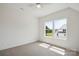 Sunlit bedroom with carpet, ceiling fan, and bright window with lawn view at 175 Lone Pine Rd, Statesville, NC 28625