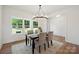Dining room with an elegant chandelier and a large window offering a view of the trees at 175 Lone Pine Rd, Statesville, NC 28625