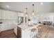 Open kitchen with large island, barstool seating, and hardwood floors flowing into the living area at 175 Lone Pine Rd, Statesville, NC 28625