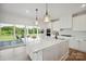 Gourmet kitchen boasts a large island and access to a screened-in porch with beautiful outdoor views at 175 Lone Pine Rd, Statesville, NC 28625