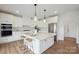 Bright, modern kitchen with white cabinets, stainless steel appliances, and a large center island at 175 Lone Pine Rd, Statesville, NC 28625
