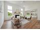 Bright living room featuring a fireplace, shiplap accent wall, hardwood floors, and large windows at 175 Lone Pine Rd, Statesville, NC 28625