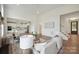 Open-concept living room featuring hardwood floors, white walls, and a view into the modern kitchen at 175 Lone Pine Rd, Statesville, NC 28625