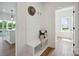 Entryway featuring a bench, shiplap accent wall, and seamless access to the kitchen and powder room at 175 Lone Pine Rd, Statesville, NC 28625