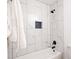 Beautiful bathroom features marble tile in shower with black hardware and blue accent at 1757 Ashcroft Ln, Rock Hill, SC 29732