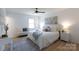 Bright bedroom with a ceiling fan, stylish decor, and a bench by the window at 1757 Ashcroft Ln, Rock Hill, SC 29732