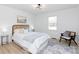 Well-lit bedroom with a comfortable bed, side tables, decorative rug and chair with stylish decor at 1757 Ashcroft Ln, Rock Hill, SC 29732
