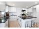 Bright kitchen featuring white cabinets, black countertops, stainless steel appliances, and an island with stool seating at 1757 Ashcroft Ln, Rock Hill, SC 29732