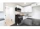 Bright kitchen featuring white cabinets, black countertops, stainless steel appliances, and a white subway tile backsplash at 1757 Ashcroft Ln, Rock Hill, SC 29732