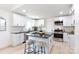 Bright kitchen featuring white cabinets, black countertops, stainless steel appliances, and an island with stool seating at 1757 Ashcroft Ln, Rock Hill, SC 29732