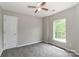 This bedroom features neutral walls, gray carpet, and a window at 183 Bellelaine Dr, Mooresville, NC 28115