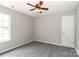 This bedroom has a ceiling fan, gray carpet, and neutral walls at 183 Bellelaine Dr, Mooresville, NC 28115