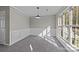 A spacious dining room features wainscoting, a large window, and modern lighting at 183 Bellelaine Dr, Mooresville, NC 28115
