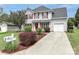 Charming two-story home with red shutters, landscaped yard, and a concrete driveway at 183 Bellelaine Dr, Mooresville, NC 28115