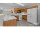 A functional kitchen with wooden cabinets and white appliances is well-lit by a window at 183 Bellelaine Dr, Mooresville, NC 28115