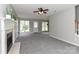 Open living room featuring a fireplace, plush carpet, and a ceiling fan at 183 Bellelaine Dr, Mooresville, NC 28115