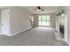 Bright living room featuring neutral carpet, a cozy fireplace, and ample natural light at 183 Bellelaine Dr, Mooresville, NC 28115