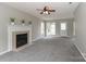 Spacious living room featuring a cozy fireplace, neutral carpet, and ample natural light at 183 Bellelaine Dr, Mooresville, NC 28115