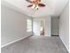 A spacious main bedroom with plush carpeting, ceiling fan, and an en-suite bathroom at 183 Bellelaine Dr, Mooresville, NC 28115