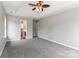 A spacious main bedroom with plush carpeting, ceiling fan, and an en-suite bathroom at 183 Bellelaine Dr, Mooresville, NC 28115