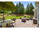 This outdoor patio features patio furniture, a table, manicured landscaping, and a beautiful view at 1900 Birchbrook Ct, Harrisburg, NC 28075